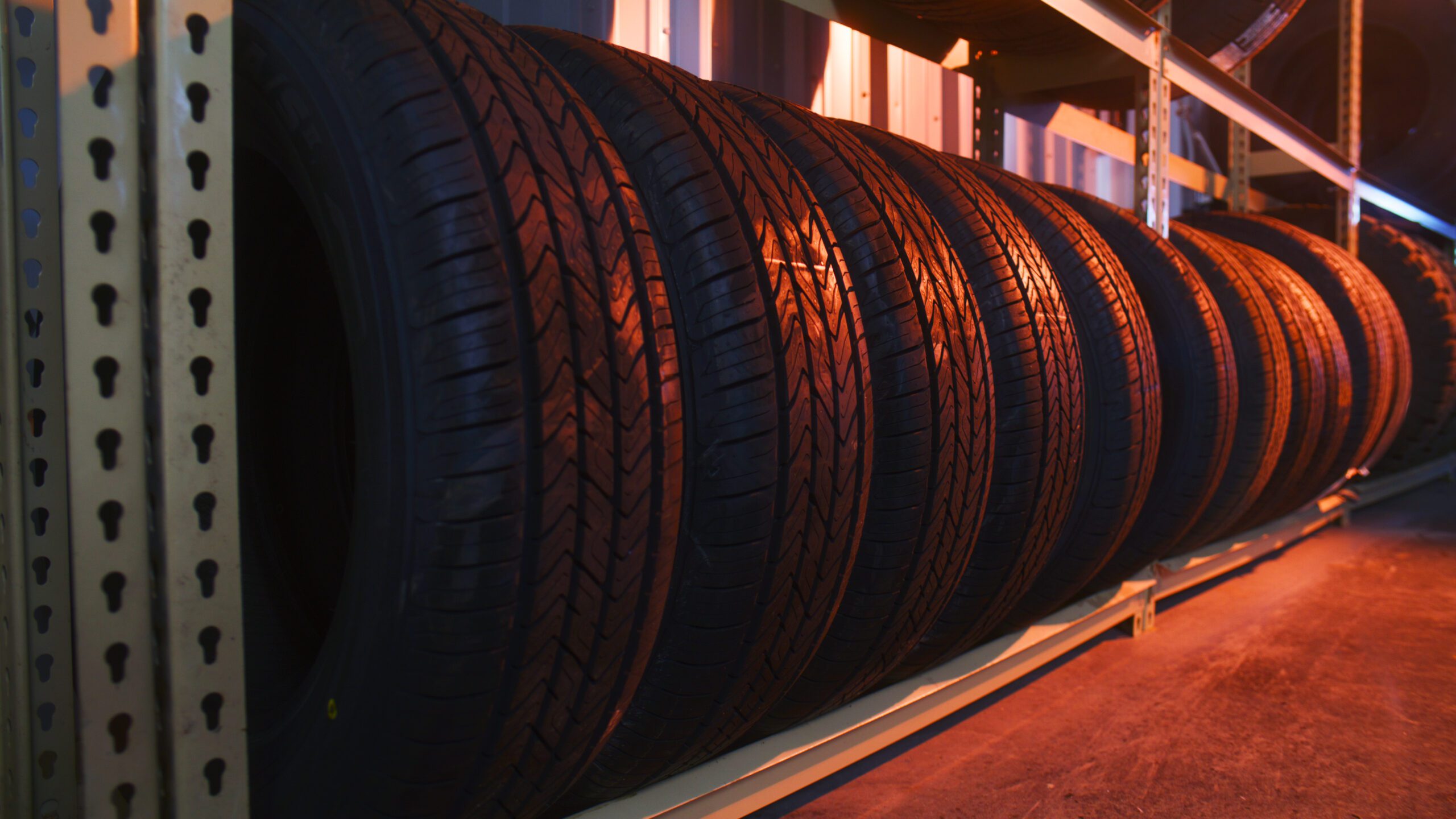 New passenger and SUV tires displayed on storage rack inside Cyclone Tires in Pueblo West, Colorado.