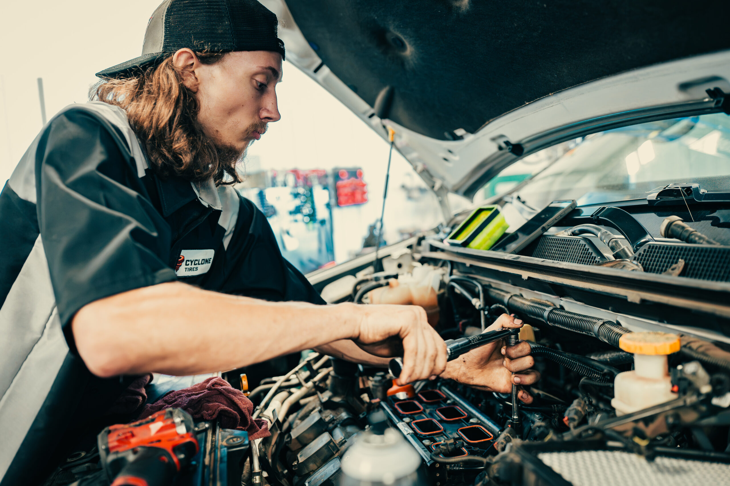 auto-tech working on car engine